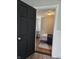 Bedroom features a door, neutral color palette, bed, desk, chair and wood-look vinyl flooring at 179 E Pearl St, Greenwood, IN 46143
