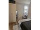 Bedroom features a neutral color palette, closet, bed, desk, chair and wood-look vinyl flooring at 179 E Pearl St, Greenwood, IN 46143