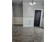 Open-concept dining room featuring modern flooring, updated lighting, and wainscoting at 179 E Pearl St, Greenwood, IN 46143