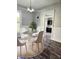 Bright dining room with modern chandelier, hardwood floors, and a table with four chairs, plus an adjacent room at 179 E Pearl St, Greenwood, IN 46143