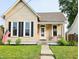 Charming single-story home with a well-manicured lawn and inviting front porch, perfect for enjoying the outdoors at 179 E Pearl St, Greenwood, IN 46143