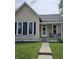 Charming single-story home featuring a cozy front porch and well-maintained landscaping at 179 E Pearl St, Greenwood, IN 46143