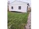 A white garage with black trimmed windows sits at the edge of a stone path and lawn at 179 E Pearl St, Greenwood, IN 46143