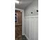Hallway with white wainscoting detail, hooks, and a view of the living area at 179 E Pearl St, Greenwood, IN 46143