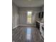 Open kitchen with wood-look floors, white countertops, and bright window view at 179 E Pearl St, Greenwood, IN 46143