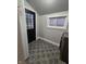 A tidy laundry room with modern appliances, sleek door, and attractive tiled flooring at 179 E Pearl St, Greenwood, IN 46143