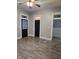 Neutral living area with modern wood floors, black doors, and easy access to other rooms at 179 E Pearl St, Greenwood, IN 46143