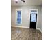 Bright living room with stylish wood flooring, neutral paint, and modern black doors at 179 E Pearl St, Greenwood, IN 46143