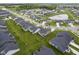 An aerial view showcases a residential area with manicured lawns and a picturesque pond with fountain at 19144 Goins Blvd, Westfield, IN 46074