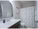 Well-lit bathroom with a decorative shower curtain, sleek vanity, modern mirror, and fresh towels at 19144 Goins Blvd, Westfield, IN 46074