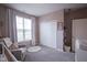 Bedroom features large windows, a cozy chair, a storage closet, and neutral-colored walls at 19144 Goins Blvd, Westfield, IN 46074