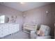 Comfortable Bedroom features pastel walls, a cozy armchair, white furniture, and a soft carpeted floor at 19144 Goins Blvd, Westfield, IN 46074