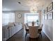 Open-concept dining room with modern chandelier, flows into a living room with comfortable seating and lots of natural light at 19144 Goins Blvd, Westfield, IN 46074