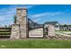 Community entrance with stone pillars and Lindley Run signage under a bright sky at 19144 Goins Blvd, Westfield, IN 46074