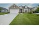 Charming home with a well-manicured lawn and attached two car garage at 19144 Goins Blvd, Westfield, IN 46074