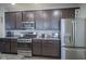 Kitchen with dark cabinets, granite countertops, and stainless steel appliances at 19144 Goins Blvd, Westfield, IN 46074