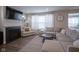 Inviting living room with a fireplace, comfortable seating, and large windows that fill the space with natural light at 19144 Goins Blvd, Westfield, IN 46074