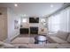 Cozy living room featuring a fireplace, comfortable seating, and ample natural light from the large windows at 19144 Goins Blvd, Westfield, IN 46074