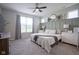 Serene main bedroom featuring a large window, decorative wall paneling, and neutral tones for a relaxing atmosphere at 19144 Goins Blvd, Westfield, IN 46074