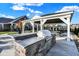 Outdoor kitchen area in a community space with a built-in grill and covered seating at 19144 Goins Blvd, Westfield, IN 46074
