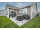 Outdoor patio with grill, covered furniture, string lights, and a well-maintained lawn for relaxation and entertainment at 19144 Goins Blvd, Westfield, IN 46074