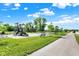 A community playground and swingset sit next to a sidewalk and beautiful lawns and trees in the neighborhood at 19144 Goins Blvd, Westfield, IN 46074