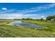 Scenic community pond surrounded by green lawns and trees, creating a serene setting for residents at 19144 Goins Blvd, Westfield, IN 46074