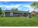 Large backyard featuring a lush lawn, mature trees and a patio area for outdoor enjoyment at 200 Forum Dr, Whiteland, IN 46184