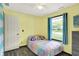 bedroom with wood-look floors, sprinkles wall decor, and a colorful plush bed at 200 Forum Dr, Whiteland, IN 46184