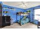 Blue bedroom featuring a bunk bed, ceiling fan, and themed decor at 200 Forum Dr, Whiteland, IN 46184