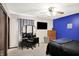 Bedroom featuring a blue accent wall, ceiling fan, vanity, and television at 200 Forum Dr, Whiteland, IN 46184