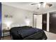 Neutral bedroom featuring a ceiling fan, two closets, and matching bedside lamps at 200 Forum Dr, Whiteland, IN 46184