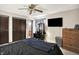 Bedroom featuring a ceiling fan, vanity area, television, and wood-look dresser at 200 Forum Dr, Whiteland, IN 46184