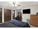 Bedroom featuring a ceiling fan, vanity area, television, and wood-look dresser at 200 Forum Dr, Whiteland, IN 46184