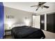 Neutral bedroom featuring a ceiling fan, two closets, and matching bedside lamps at 200 Forum Dr, Whiteland, IN 46184