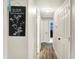 Hallway with wood-look flooring and neutral wall colors, accented by wall decor at 200 Forum Dr, Whiteland, IN 46184