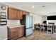 Open concept kitchen featuring wood cabinets, stainless refrigerator, and eat in kitchen area at 200 Forum Dr, Whiteland, IN 46184