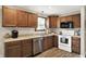 Well-lit kitchen featuring warm cabinetry, stainless steel appliances, and modern fixtures at 200 Forum Dr, Whiteland, IN 46184