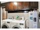 Functional laundry area with washer, dryer, and overhead cabinets at 200 Forum Dr, Whiteland, IN 46184
