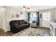 Inviting living room featuring a comfortable sofa, patterned armchair, and light-filled ambiance at 200 Forum Dr, Whiteland, IN 46184