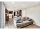 Living area with wood-look floors, gray sofa, and adjacent kitchen and dining area at 200 Forum Dr, Whiteland, IN 46184