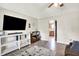 Bright living room with modern shelving and decor, light-colored walls, and wood-look floors at 200 Forum Dr, Whiteland, IN 46184