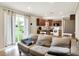 Living area with gray sofa, and view of the kitchen, dining area and backyard at 200 Forum Dr, Whiteland, IN 46184