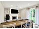 Open living room featuring dining space, a fireplace, and backyard views at 200 Forum Dr, Whiteland, IN 46184