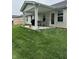 Relaxing covered patio featuring comfortable seating, a grill, and a well-maintained lawn at 200 Mission Terrace Dr, Whiteland, IN 46184