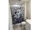 Cozy bathroom featuring a shower with a decorative curtain, toilet, and essential fixtures at 200 Mission Terrace Dr, Whiteland, IN 46184
