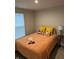Cozy bedroom with a bed covered in a peach blanket, soft pillows, and a side table, offering a peaceful retreat at 200 Mission Terrace Dr, Whiteland, IN 46184
