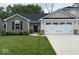 Charming single-story home featuring stone accents, a well-manicured lawn, and an attached two car garage at 200 Mission Terrace Dr, Whiteland, IN 46184