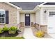 Detailed view of the front entrance, featuring stone accents and landscaped surroundings at 200 Mission Terrace Dr, Whiteland, IN 46184