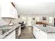 Bright kitchen featuring granite countertops, white cabinetry, stainless steel appliances, and an eat-in dining area at 200 Mission Terrace Dr, Whiteland, IN 46184